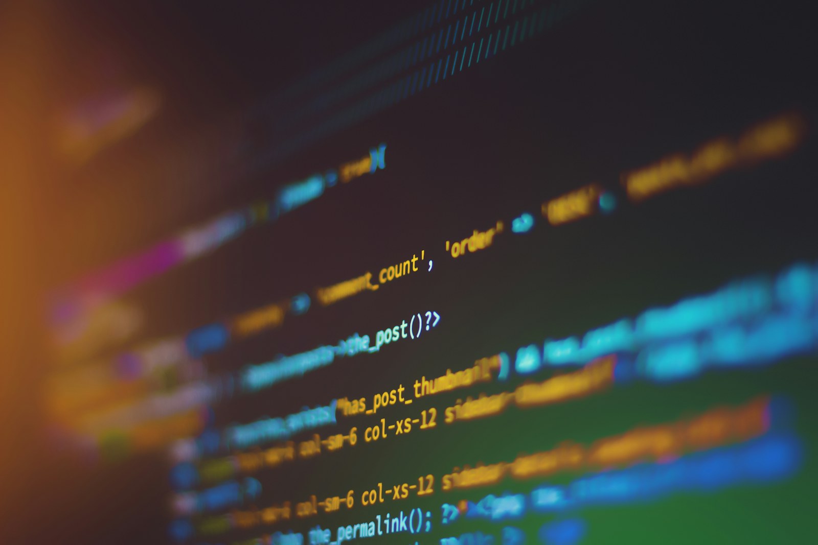 Developer working with code on multiple screens