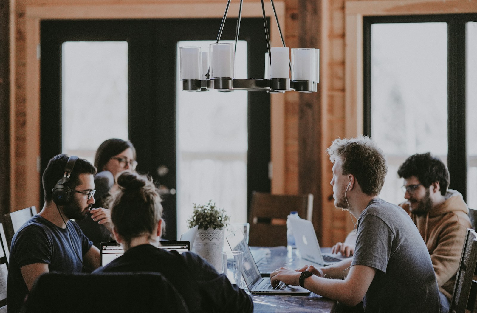 An engineering team talking around a table in a bright room